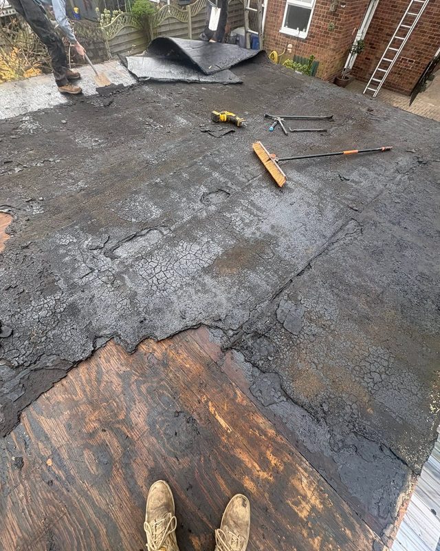 Old cracked flat roof with rotten decking before AC Roofing replaced it