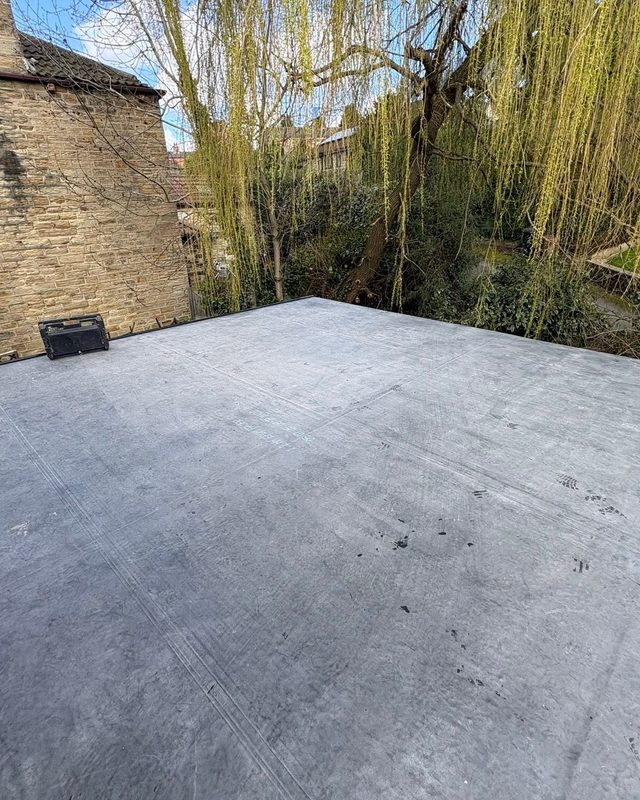 Rebuilt wall and new rubber flat roof with fascias and guttering by AC Roofing