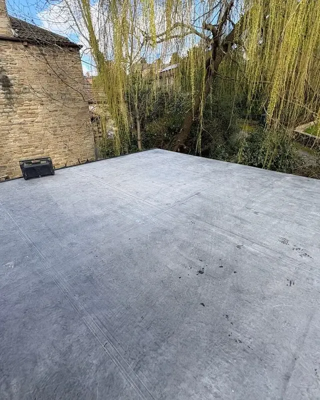 Rebuilt wall and new rubber flat roof with fascias and guttering by AC Roofing