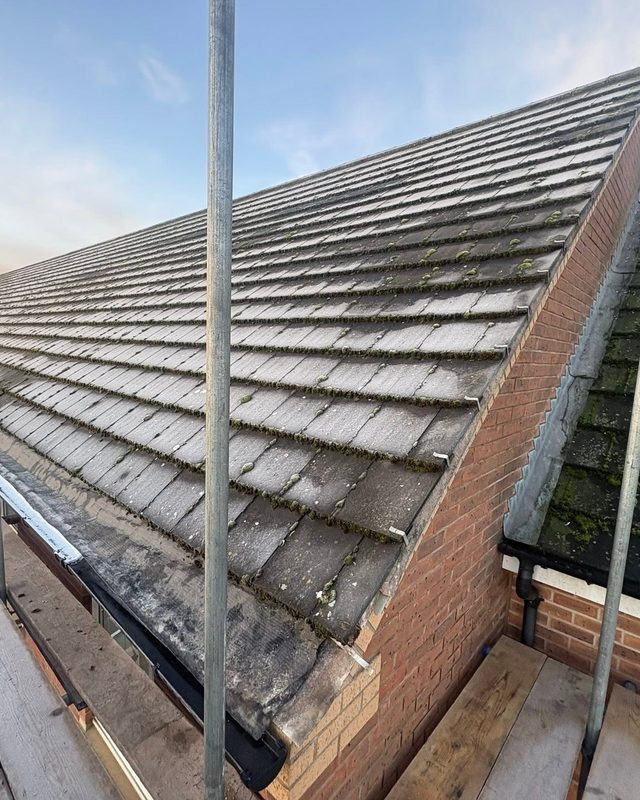 Worn mossy tiled roof before re-roofing by AC Roofing in Sheffield