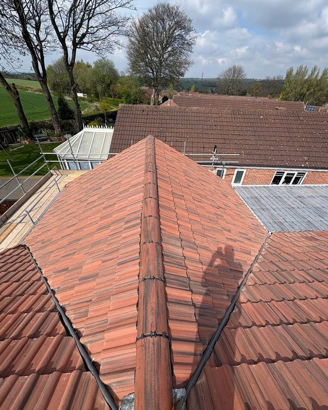 Cleaned and repointed pitched tiled roof by AC Roofing