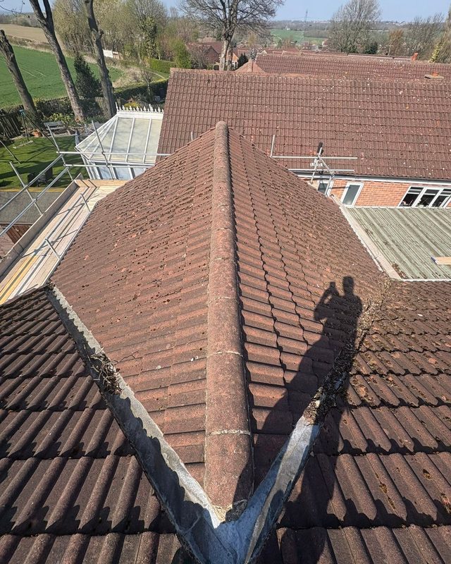 Weathered pitched tiled roof before work by AC Roofing