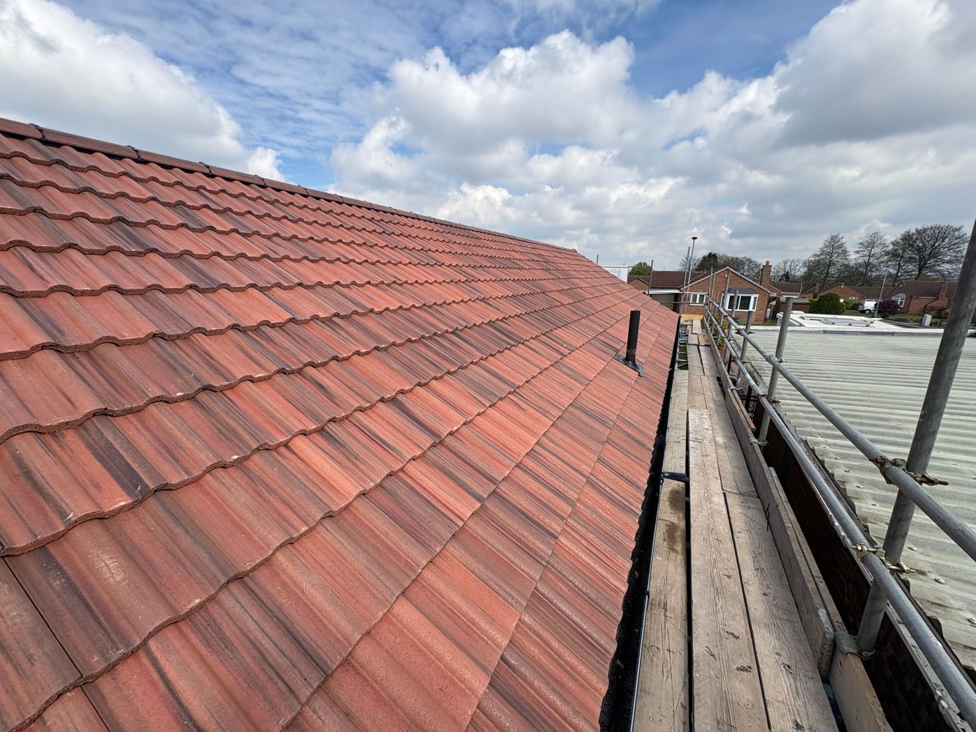Clean, restored red clay tile roof by AC Roofing